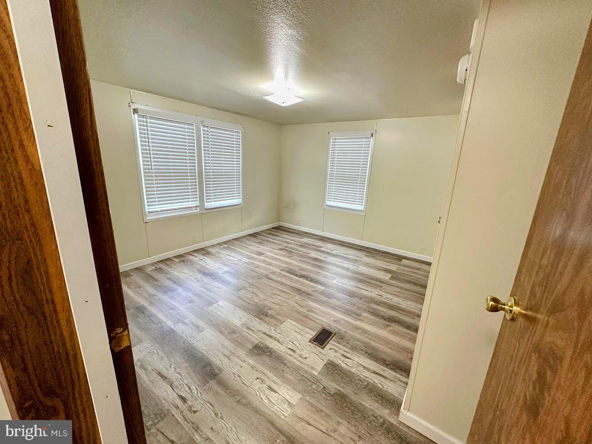 19 Gordon Drive Dover, DE 19901 - Photo 18 of 19 a view of an empty room with wooden floor and a window
