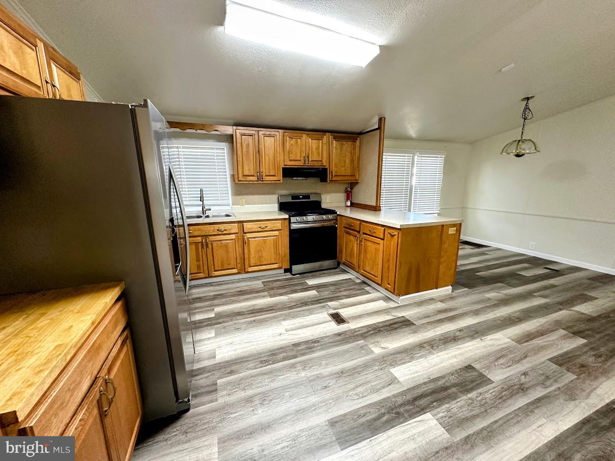 19 Gordon Drive Dover, DE 19901 - Photo 7 of 19 a kitchen with stainless steel appliances granite countertop a refrigerator and a stove top oven