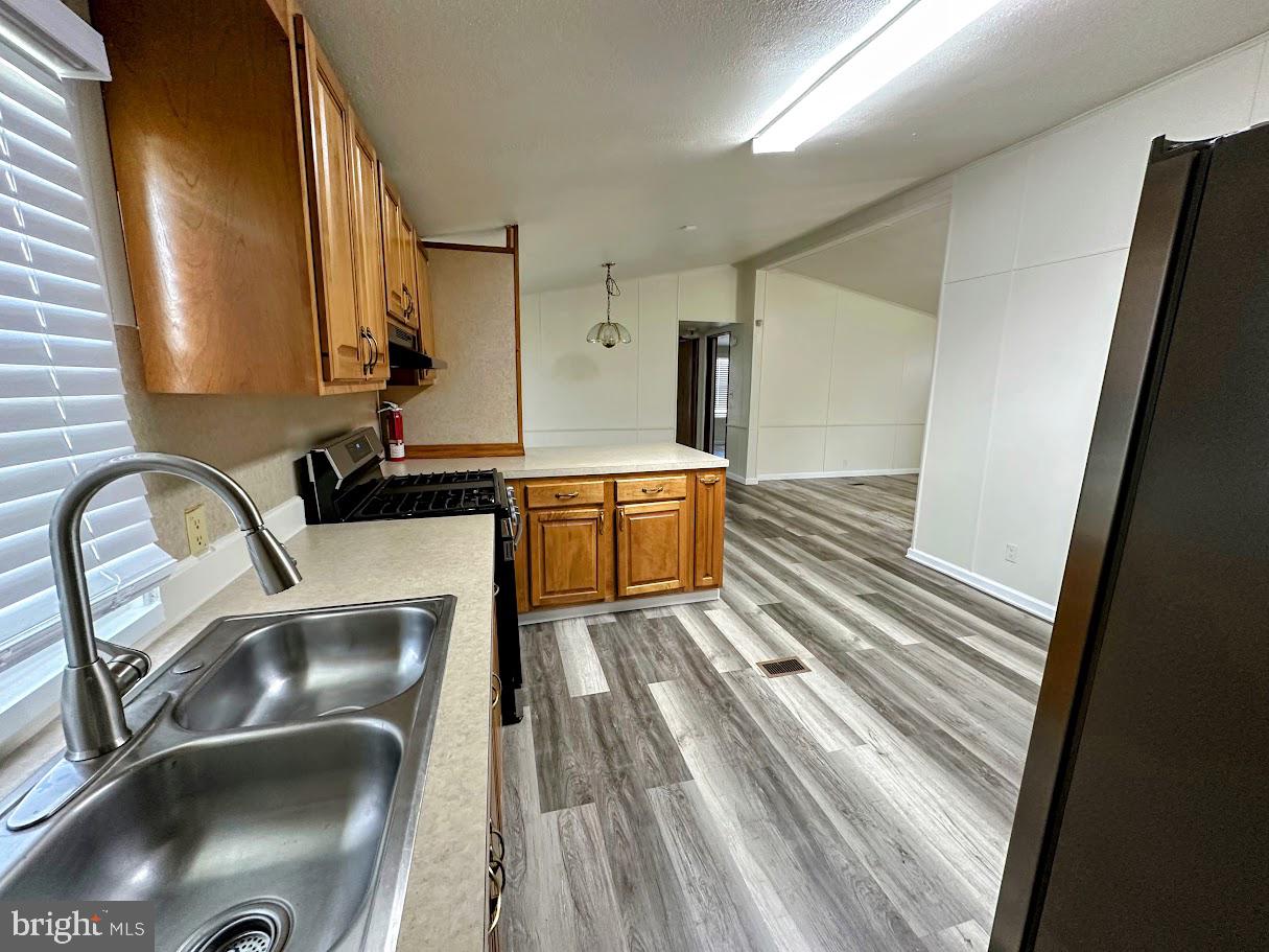 19 Gordon Drive Dover, DE 19901 - Photo 8 of 19 a kitchen with a sink and a stove top oven