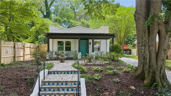 a front view of a house with garden
