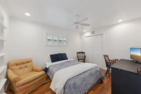 a bedroom with a bed and a chair