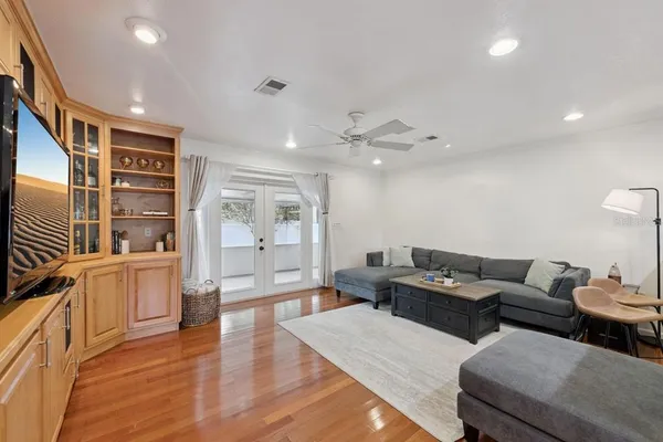 a living room with furniture and wooden floor