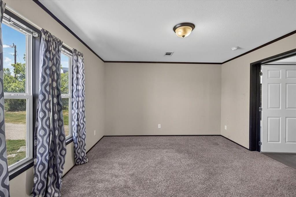 1129 Ragsdale Street Terrell, TX 75160 - Photo 7 of 29 Split Primary bedroom with lots of natural light.