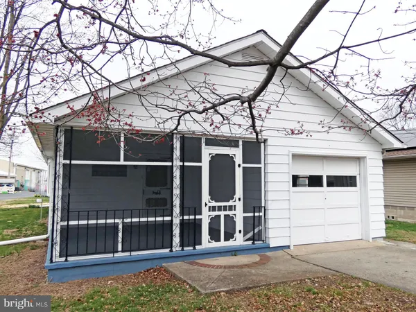 a view of a house with a small yard and wooden fence