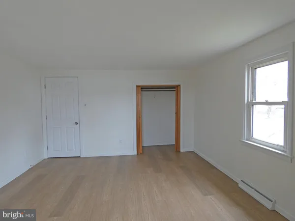 a view of an empty room and a window