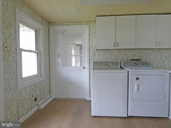 a room with a window and a washer dryer