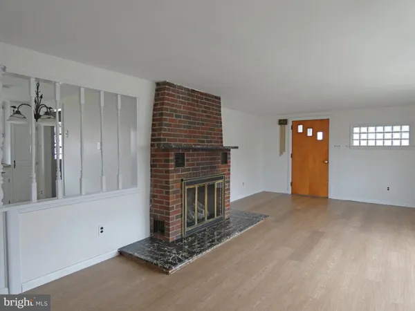 a view of an empty room with a fireplace