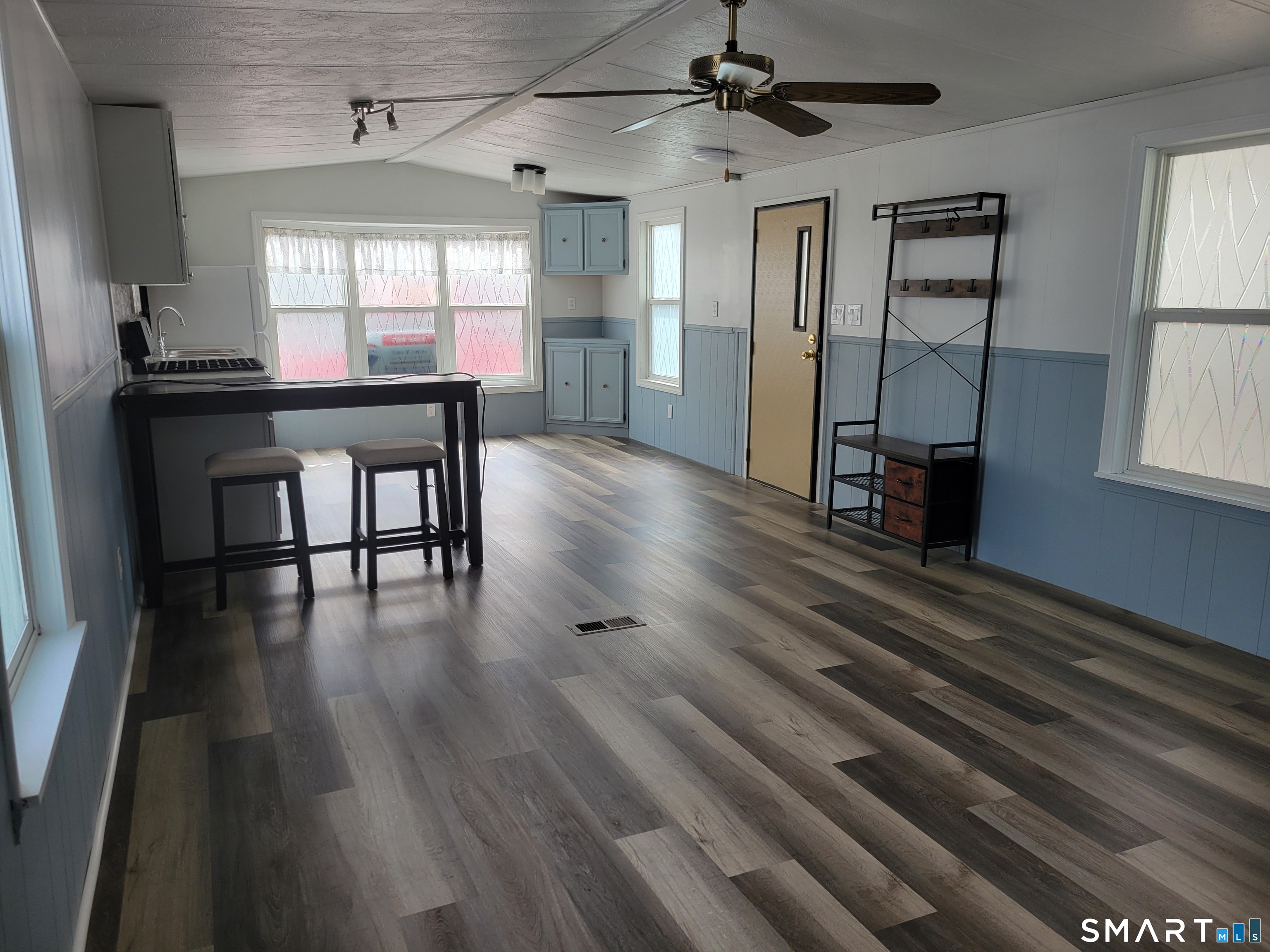 1290 N Road Groton, CT 06340 - Photo 5 of 11 an empty room with wooden floor and windows