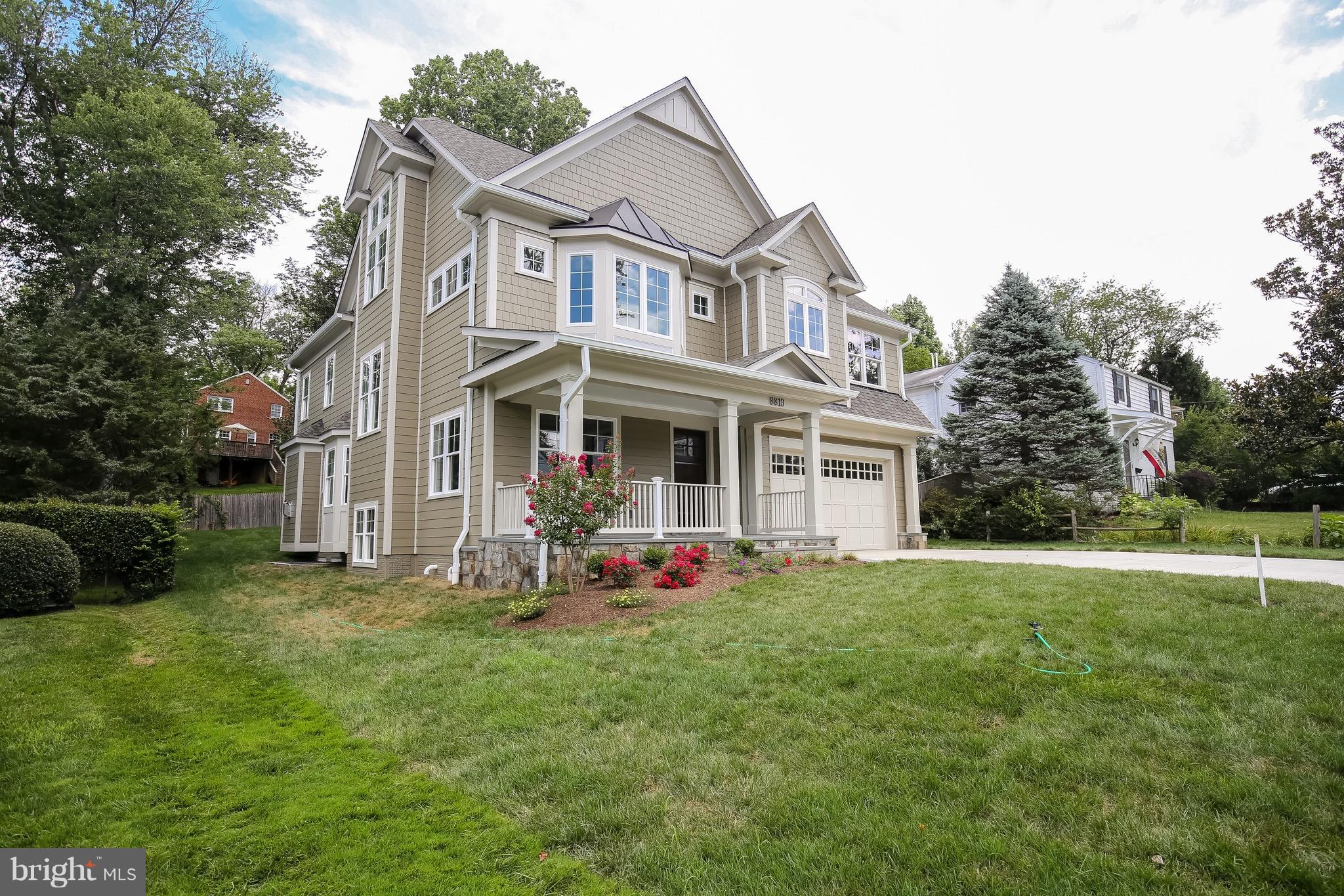 8813 Ridge Road Bethesda, MD 20817 - Photo 2 of 30 a front view of house with yard and trees in the background