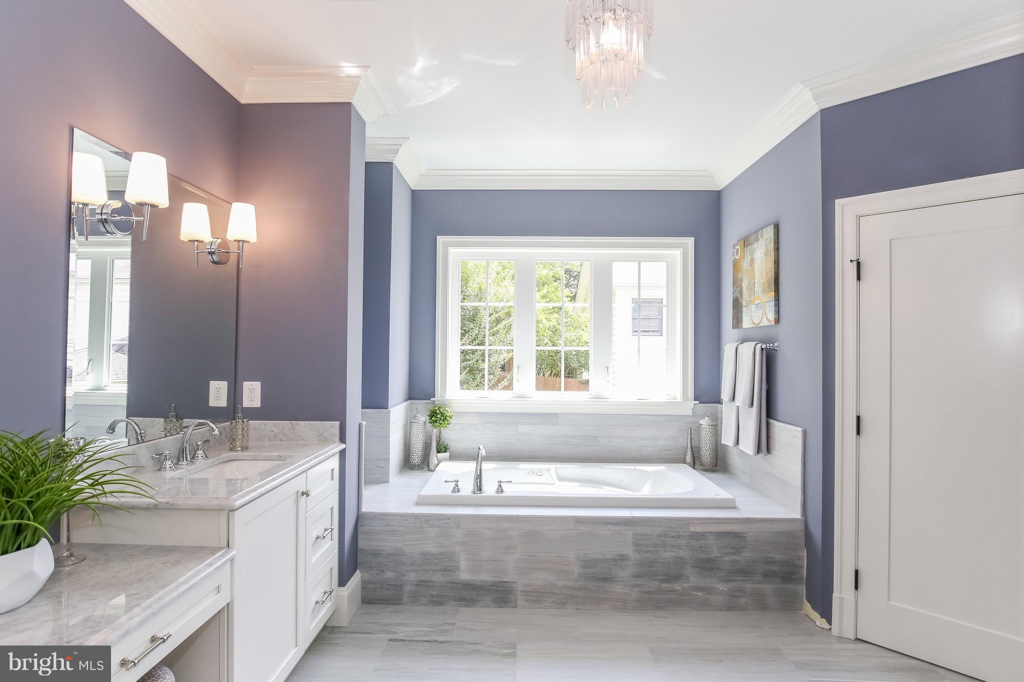8813 Ridge Road Bethesda, MD 20817 - Photo 15 of 30 a spacious bathroom with a tub sink and mirror