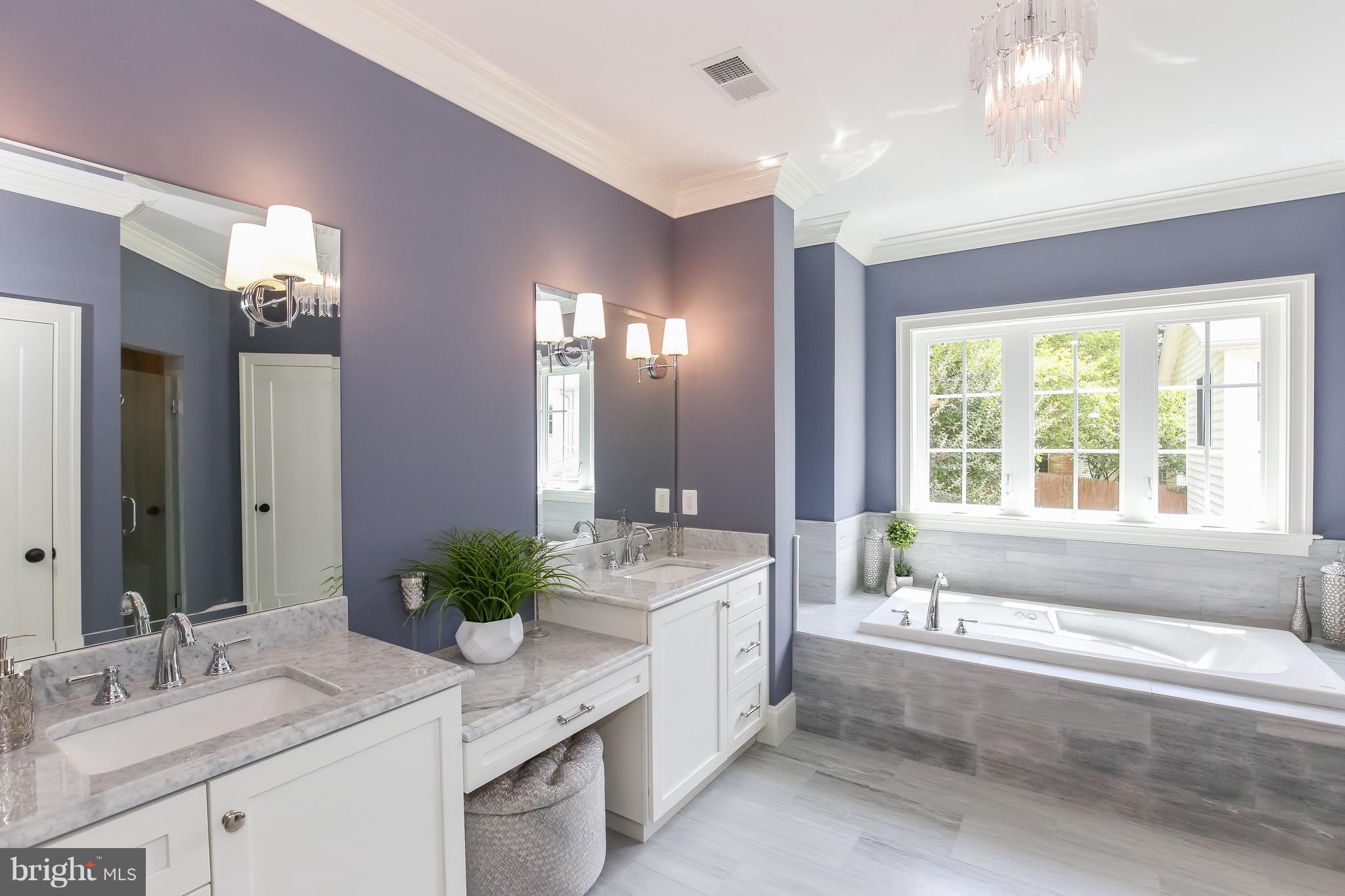 8813 Ridge Road Bethesda, MD 20817 - Photo 16 of 30 a bathroom with a granite countertop bathtub a sink and a large mirror