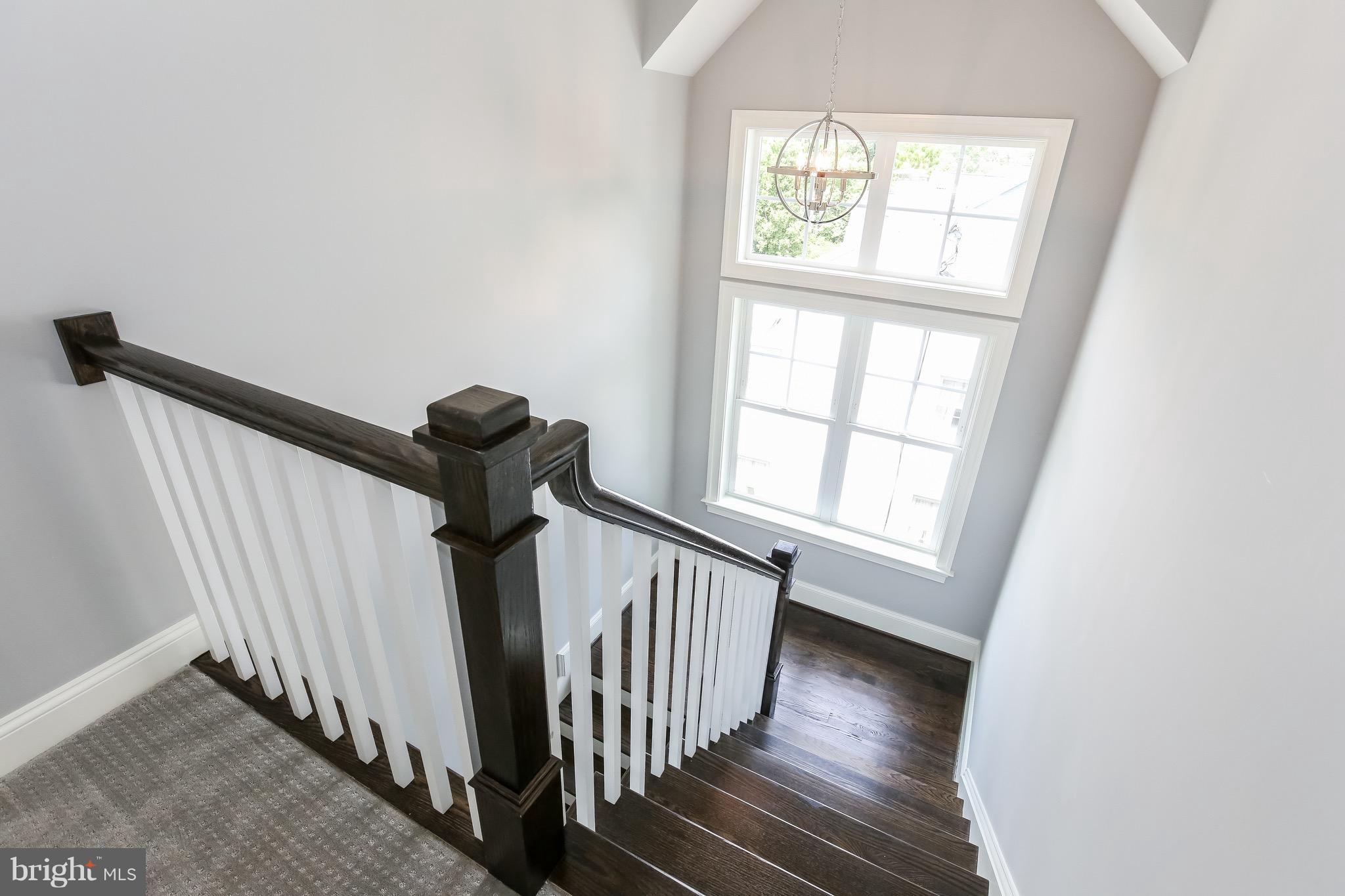 8813 Ridge Road Bethesda, MD 20817 - Photo 18 of 30 a view of a hallway with wooden floor and stairs
