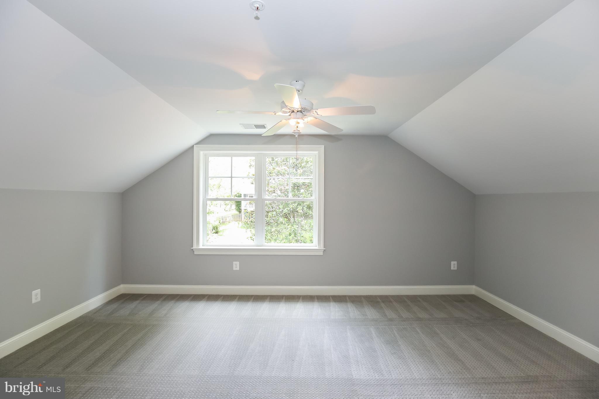 8813 Ridge Road Bethesda, MD 20817 - Photo 20 of 30 an empty room with a window and a chandelier fan