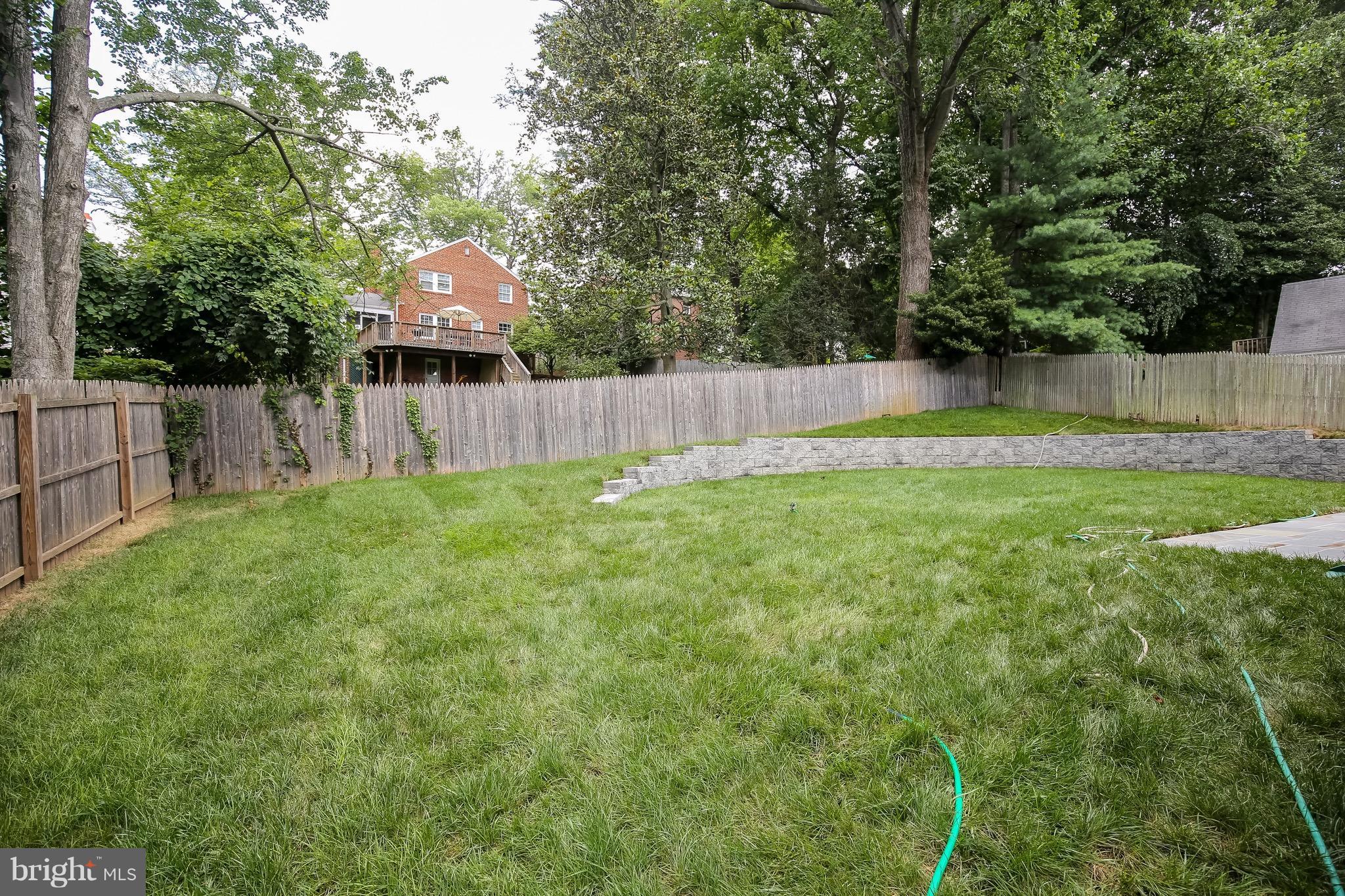 8813 Ridge Road Bethesda, MD 20817 - Photo 25 of 30 a view of a backyard with a small cabin and wooden fence