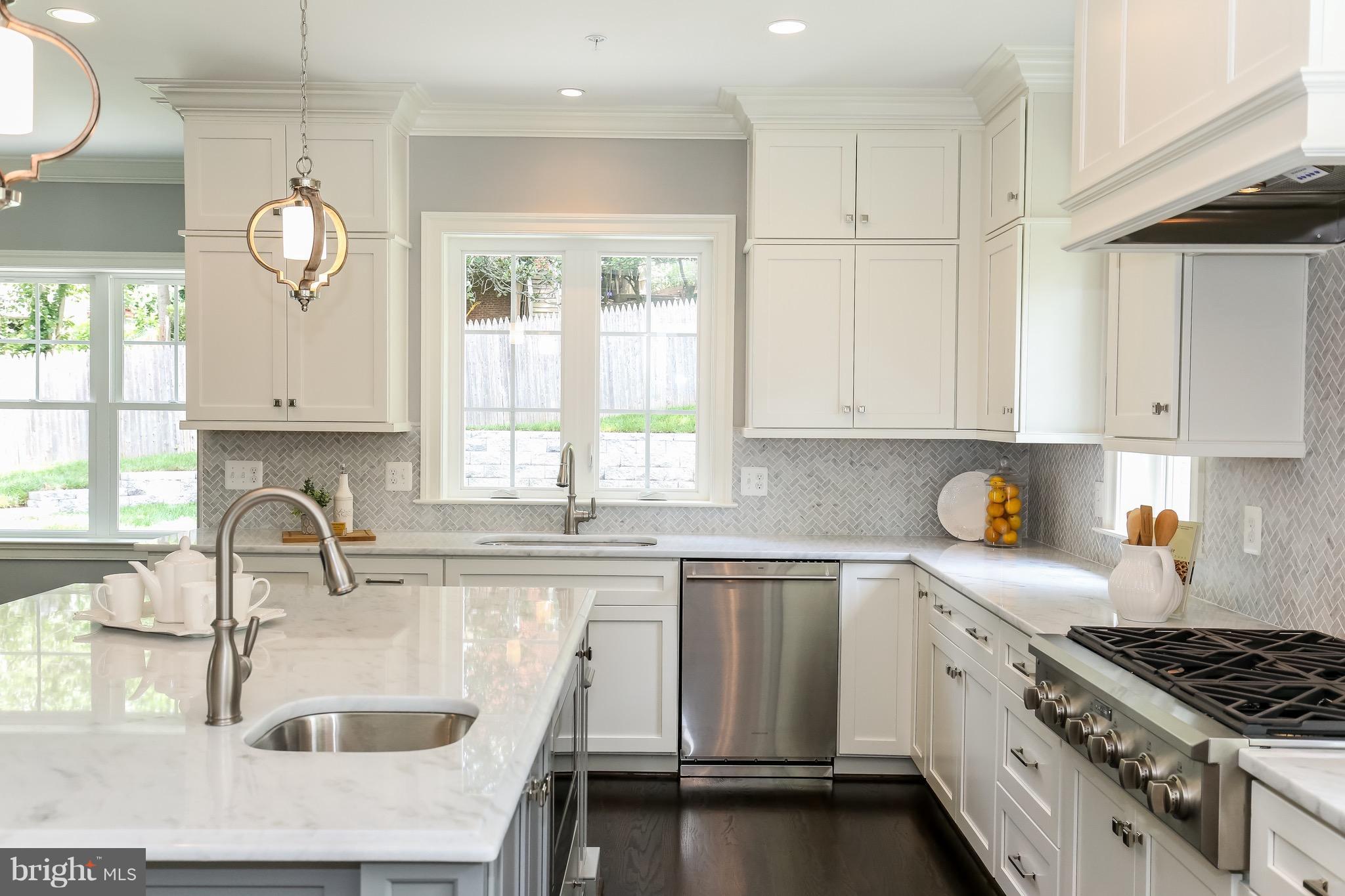 8813 Ridge Road Bethesda, MD 20817 - Photo 7 of 30 a kitchen with granite countertop a sink a stove and cabinets
