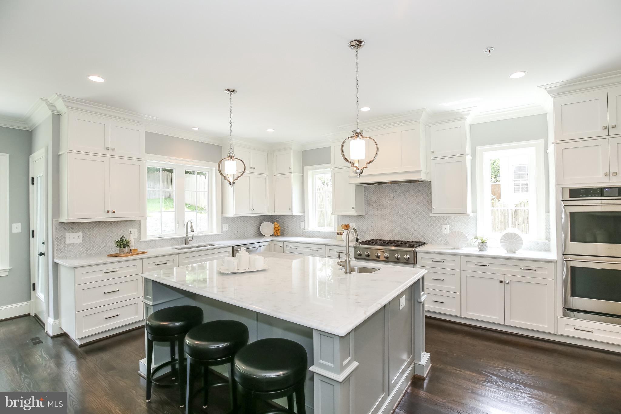 8813 Ridge Road Bethesda, MD 20817 - Photo 8 of 30 a kitchen with a stove a sink a center island and cabinets