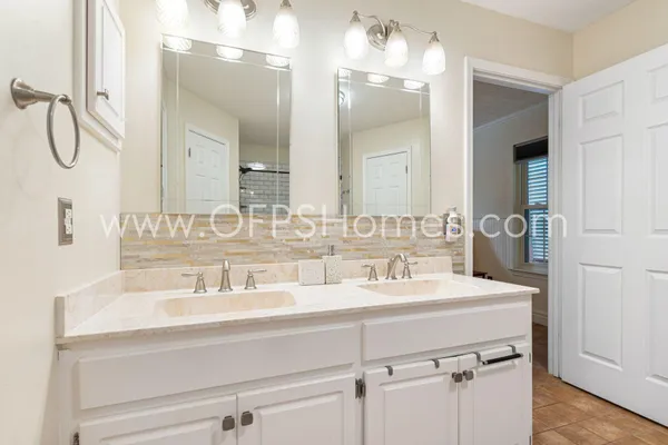 a bathroom with a sink double vanity and a mirror
