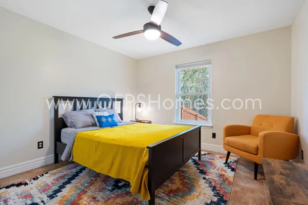 a bed room with a bed and a chair