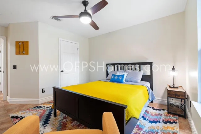 a bedroom with a bed and a chandelier