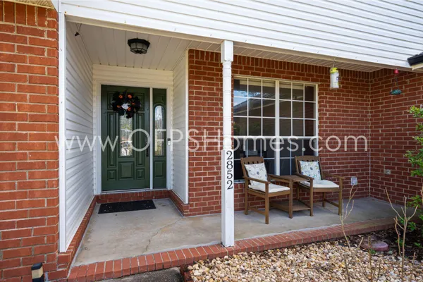 a view of a patio with a table and chairs and floor to ceiling window