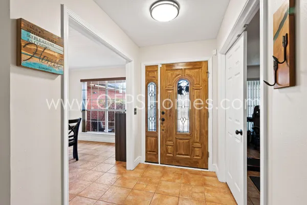 a view of a hallway with wooden shelves
