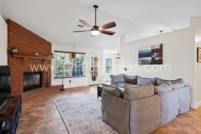 a living room with furniture and a fireplace