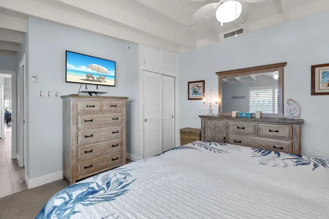 a bedroom with a large bed and a window