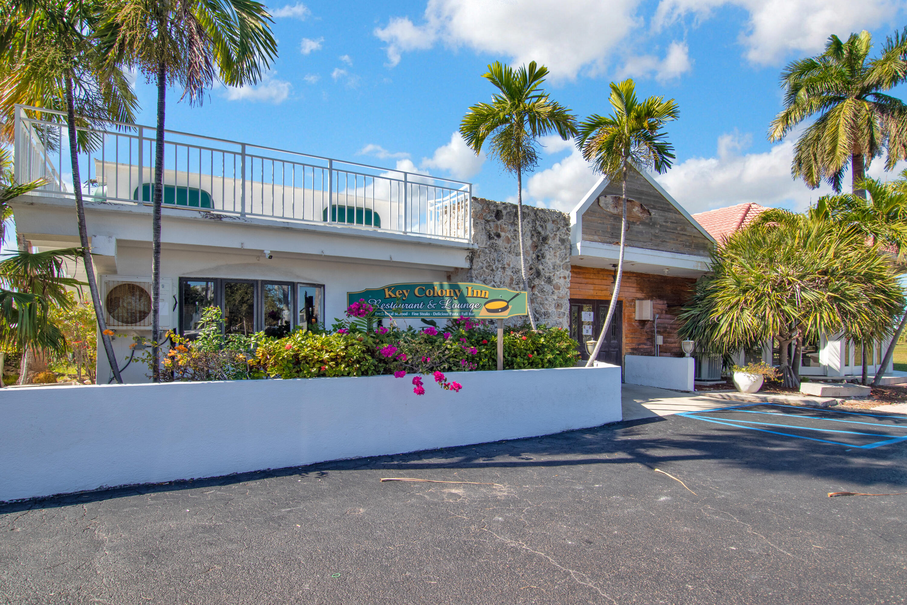 8 Sadowski Key Key Colony Beach, FL 33051 - Photo 41 of 57 front view of house with a yard and palm trees