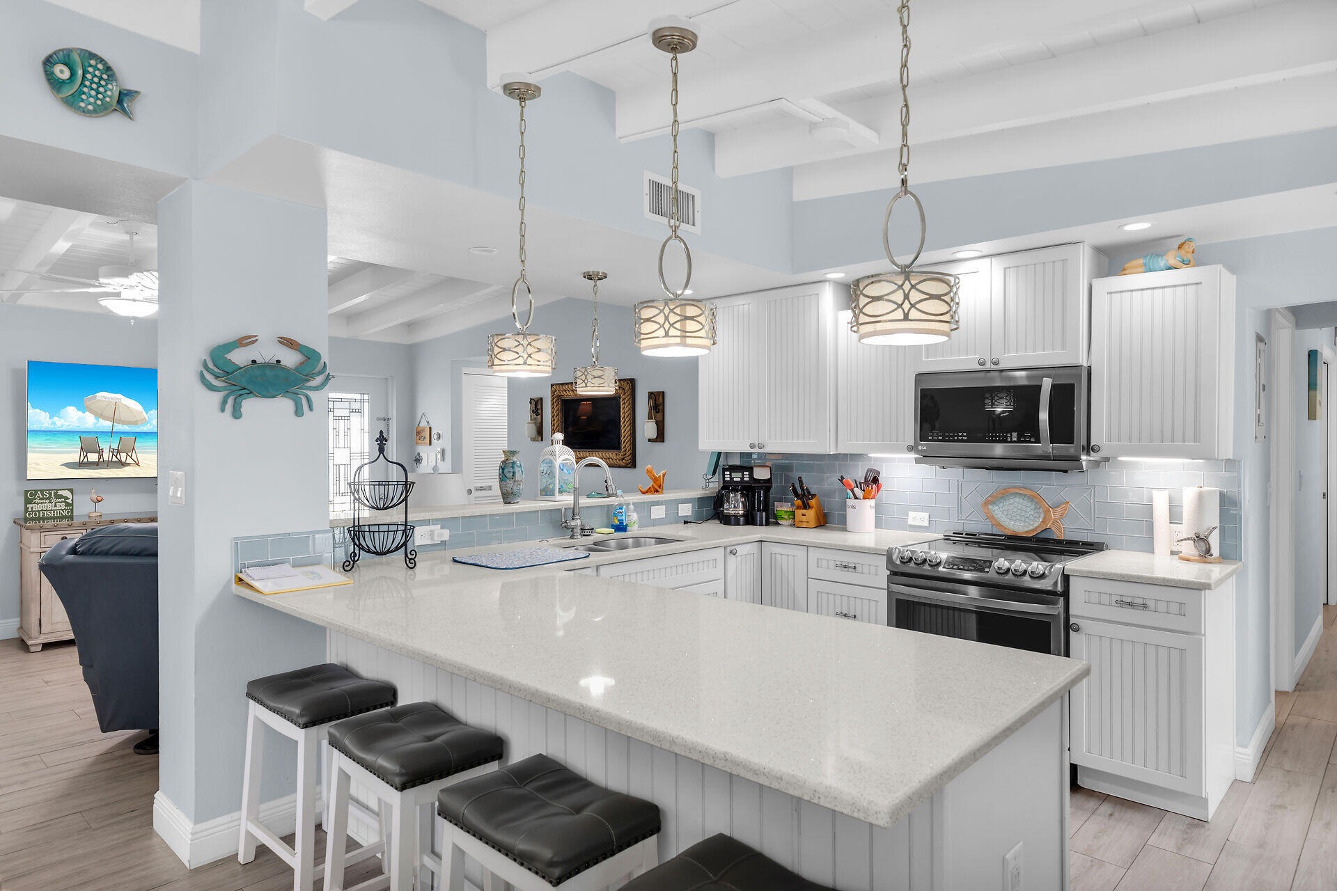 8 Sadowski Key Key Colony Beach, FL 33051 - Photo 8 of 57 a kitchen with stainless steel appliances kitchen island granite countertop a island a stove a sink a dining table and chairs with wooden floor