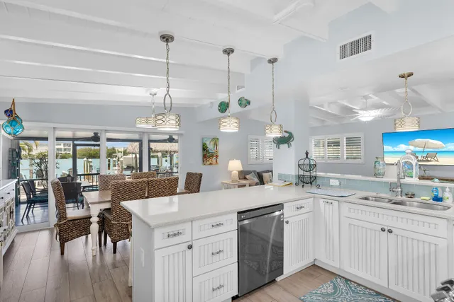 a kitchen with a sink a stove and cabinets