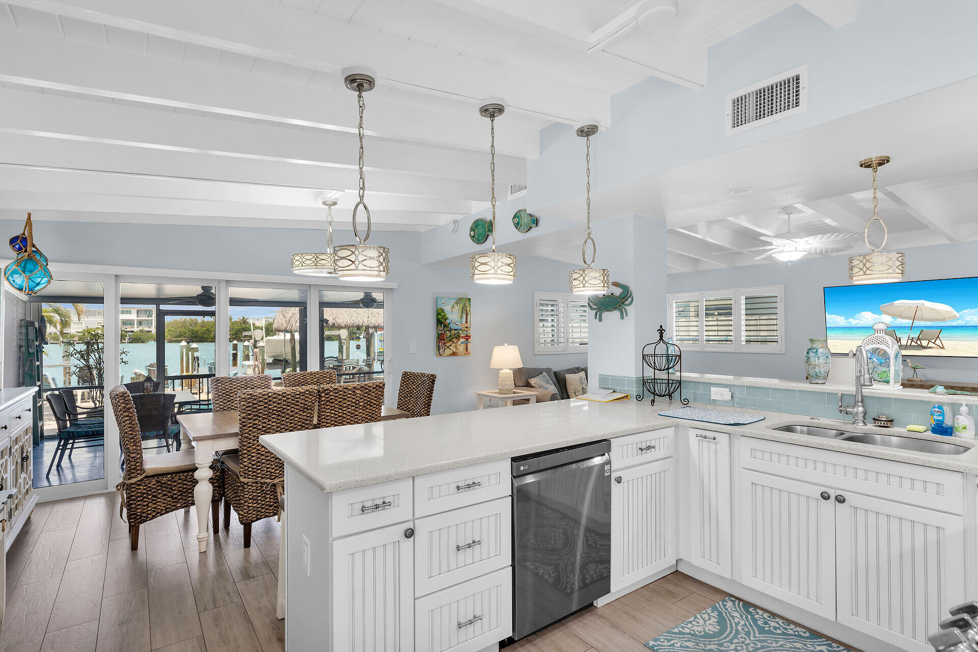 8 Sadowski Key Key Colony Beach, FL 33051 - Photo 9 of 57 a large kitchen with kitchen island a island a sink a stove and wooden floors