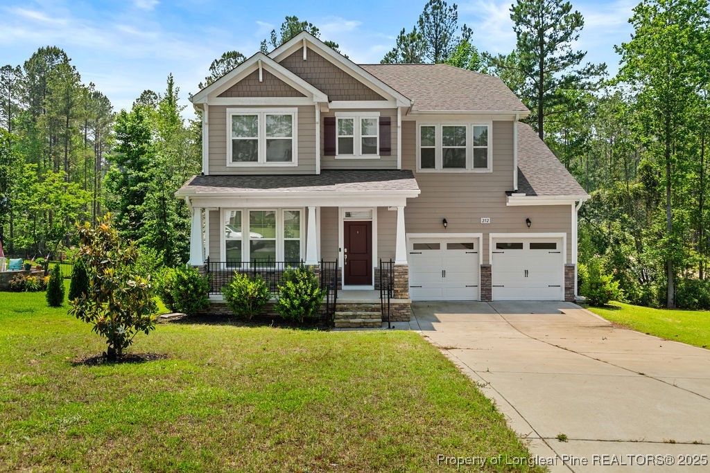 252 School Side Drive Spring Lake, NC 28390 - Photo 1 of 35 a front view of a house with a yard and garage