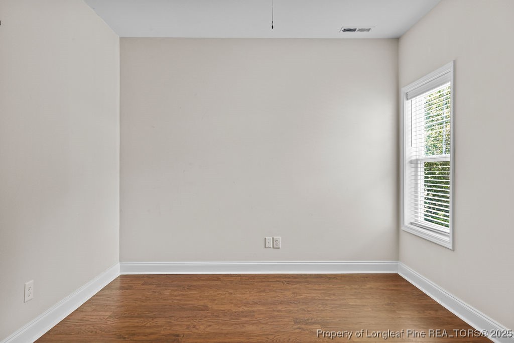 252 School Side Drive Spring Lake, NC 28390 - Photo 12 of 35 a view of an empty room with wooden floor and a window