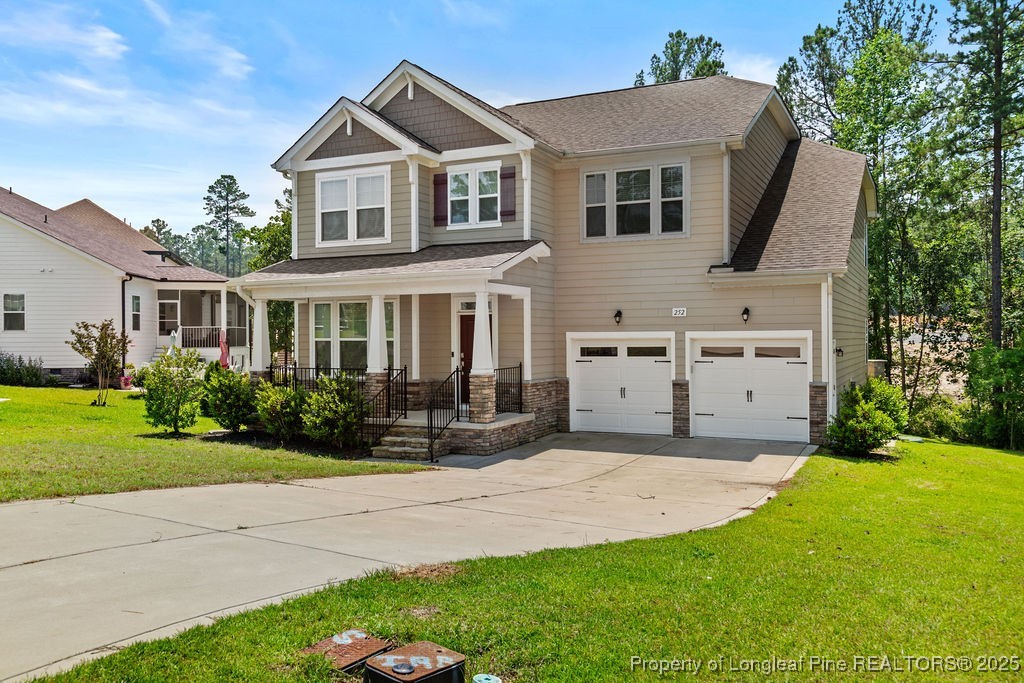 252 School Side Drive Spring Lake, NC 28390 - Photo 2 of 35 a front view of a house with a yard and porch