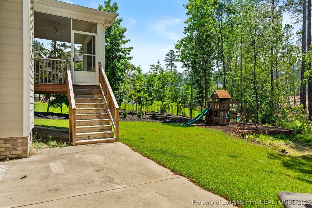 252 School Side Drive Spring Lake, NC 28390 - Photo 29 of 35 a view of a house with backyard and a tree