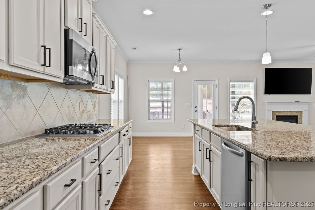 252 School Side Drive Spring Lake, NC 28390 - Photo 5 of 35 a kitchen with stainless steel appliances granite countertop a sink stove and cabinets