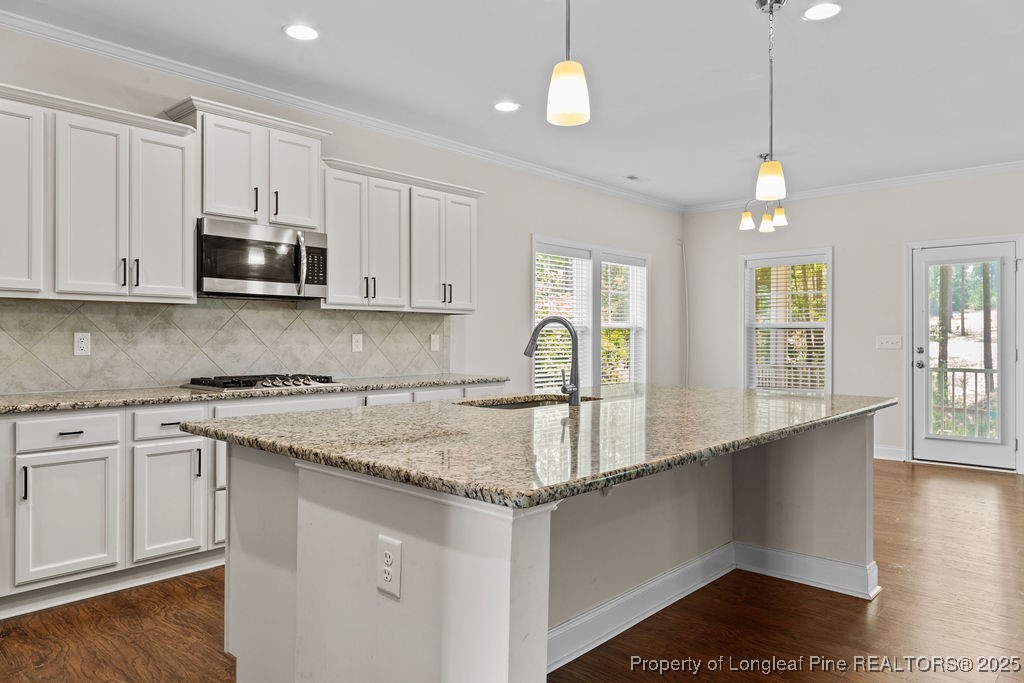 252 School Side Drive Spring Lake, NC 28390 - Photo 6 of 35 a kitchen with stainless steel appliances granite countertop a sink a stove and a wooden floors