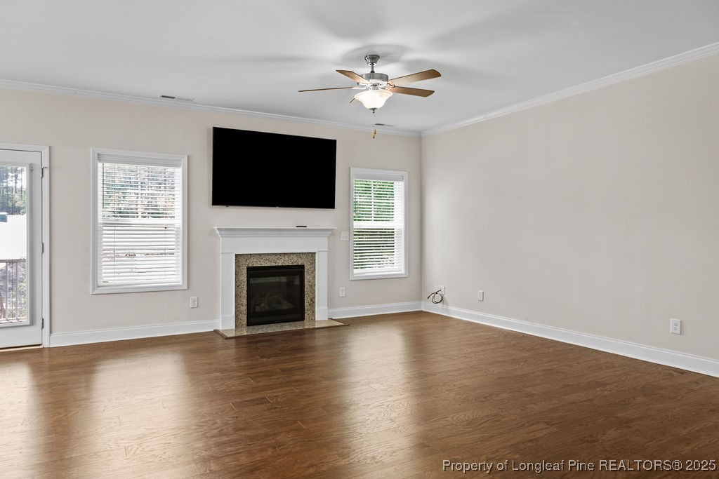 252 School Side Drive Spring Lake, NC 28390 - Photo 9 of 35 a view of an empty room with wooden floor fireplace and a window