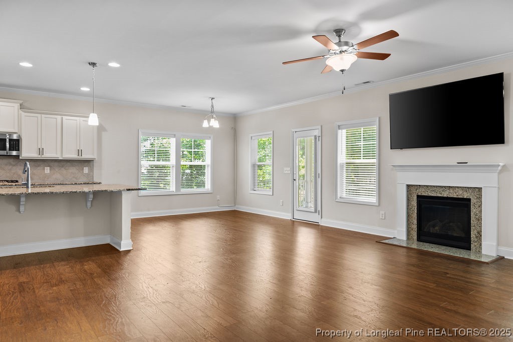 252 School Side Drive Spring Lake, NC 28390 - Photo 10 of 35 an empty room with windows fireplace and wooden floor