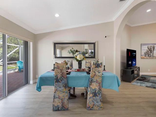 a room with gym equipment and wooden floor