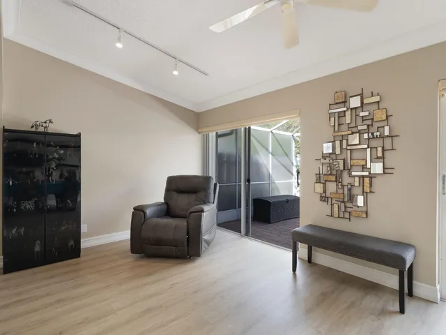 a dining hall with stainless steel appliances kitchen island granite countertop a table chairs and a refrigerator