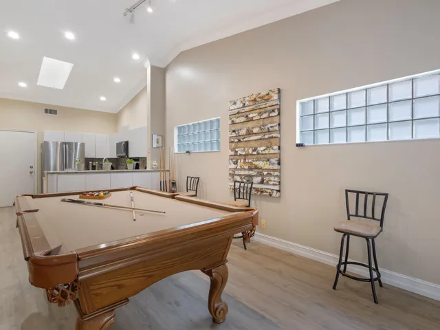 a view of a workspace with furniture and a book shelf