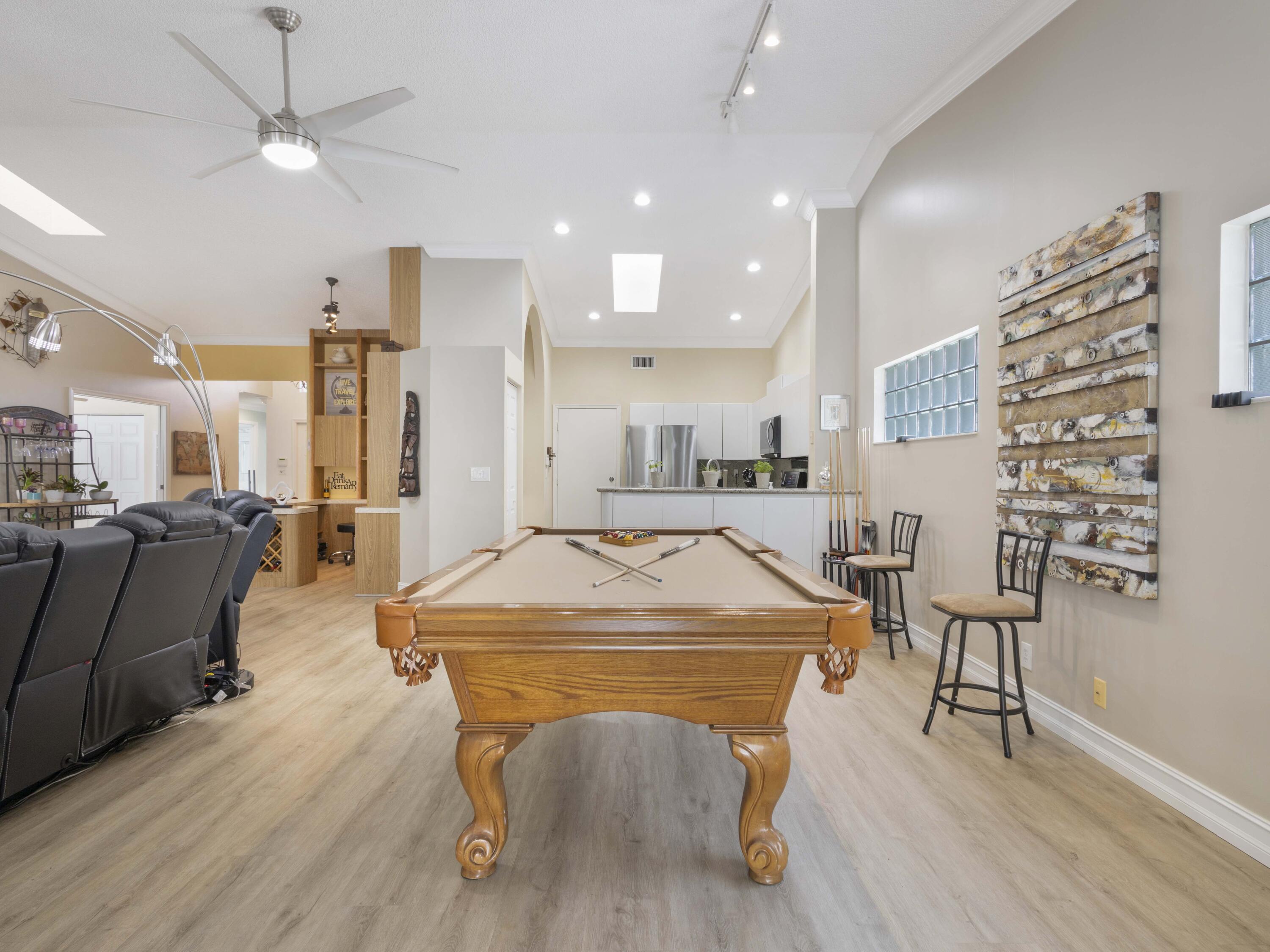 9734 Harbour Lake Circle Boynton Beach, FL 33437 - Photo 17 of 41 a dining hall with stainless steel appliances kitchen island granite countertop a table chairs and a refrigerator