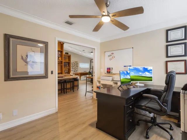 a bedroom with a bed and a ceiling fan
