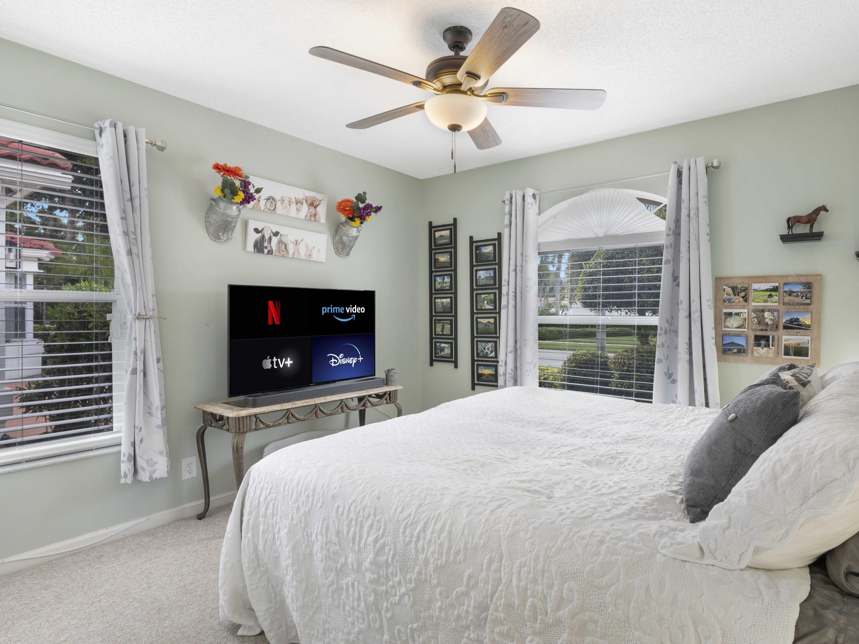 9734 Harbour Lake Circle Boynton Beach, FL 33437 - Photo 20 of 41 a bedroom with a bed and a flat screen tv