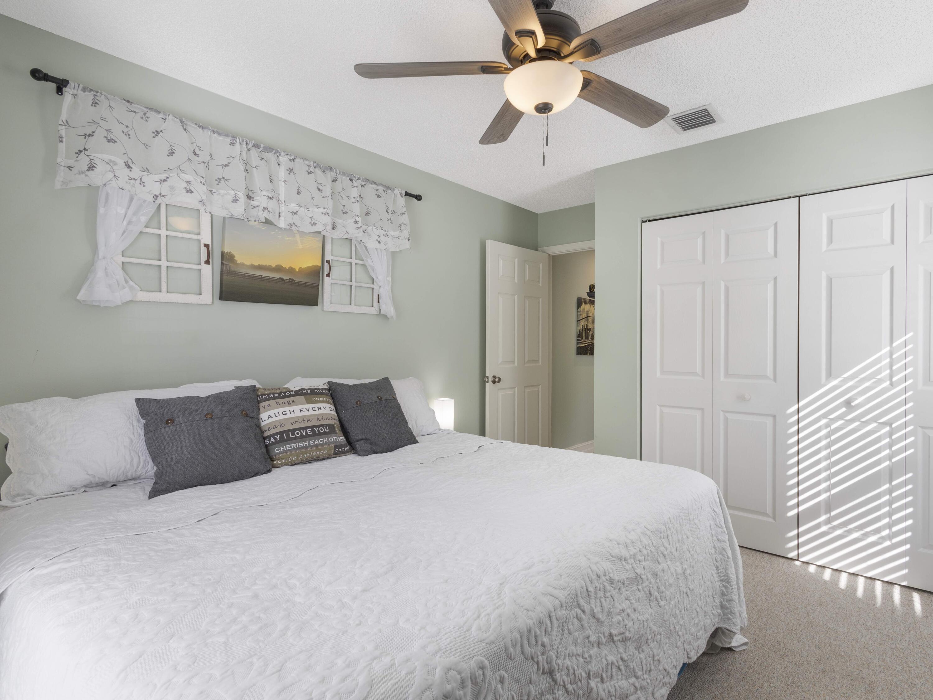 9734 Harbour Lake Circle Boynton Beach, FL 33437 - Photo 21 of 41 a bedroom with a bed and a ceiling fan