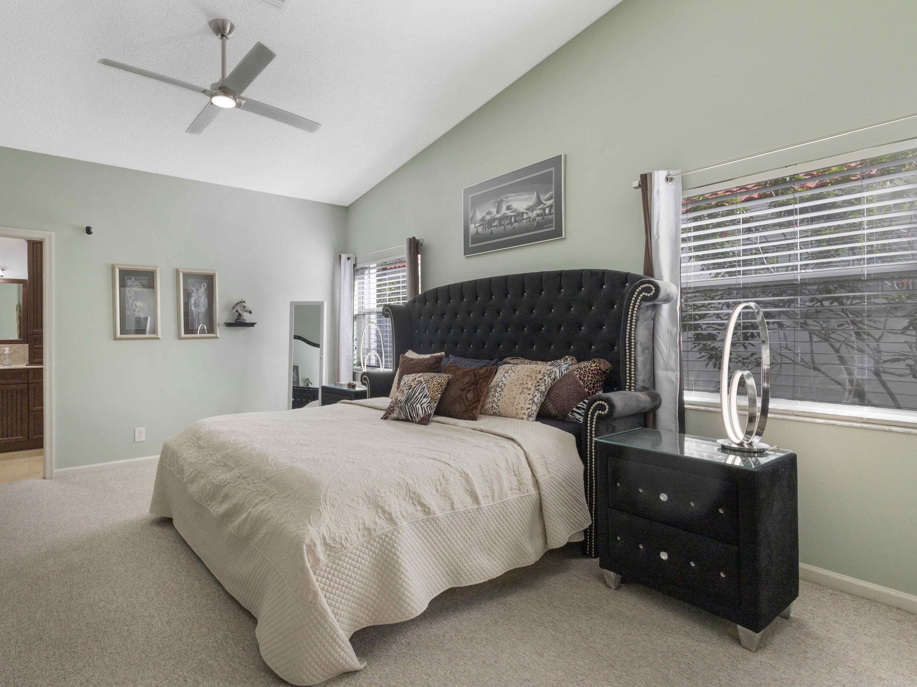 9734 Harbour Lake Circle Boynton Beach, FL 33437 - Photo 23 of 41 a bedroom with a bed and window