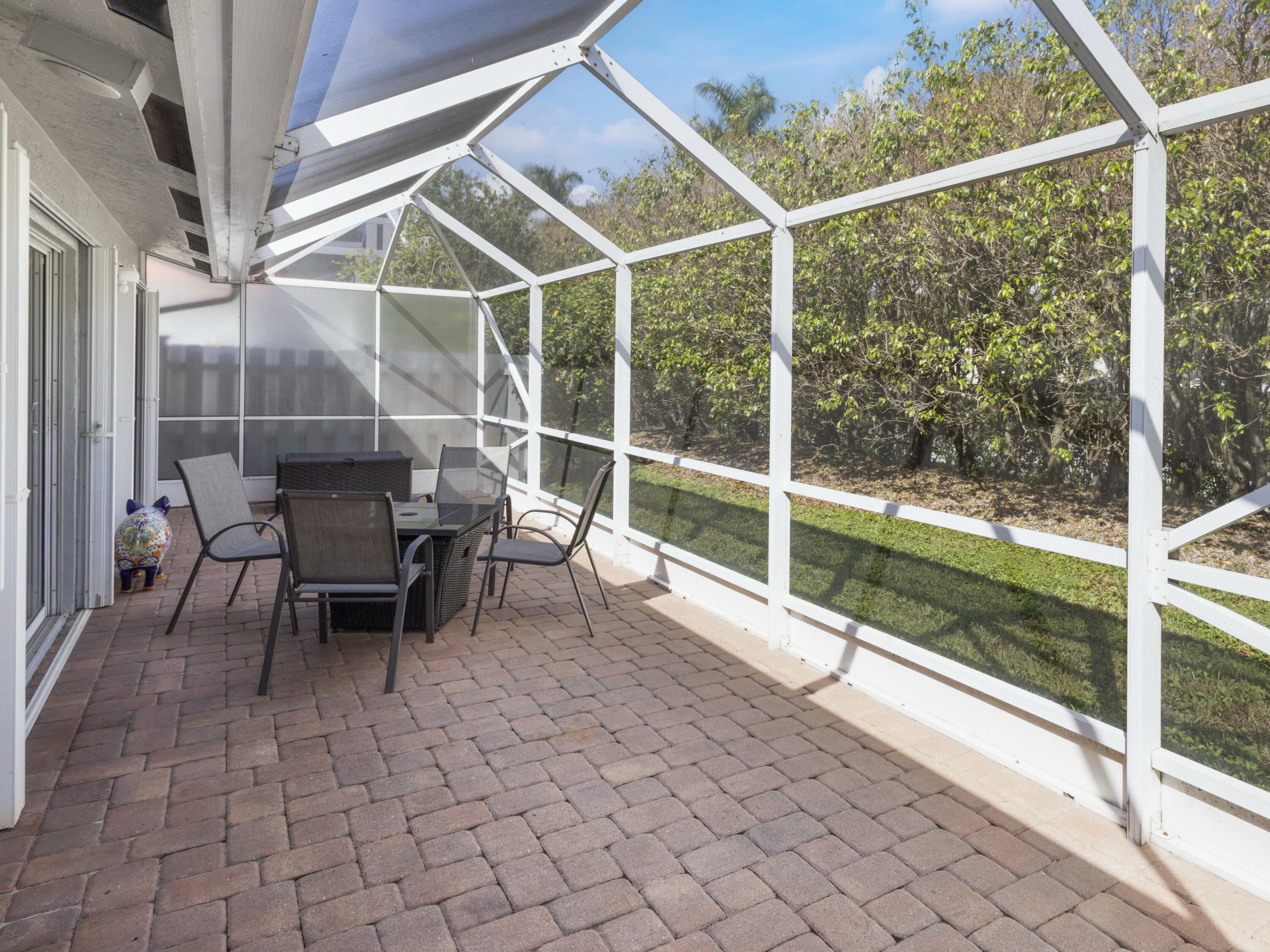 9734 Harbour Lake Circle Boynton Beach, FL 33437 - Photo 28 of 41 a view of a porch with chairs and backyard