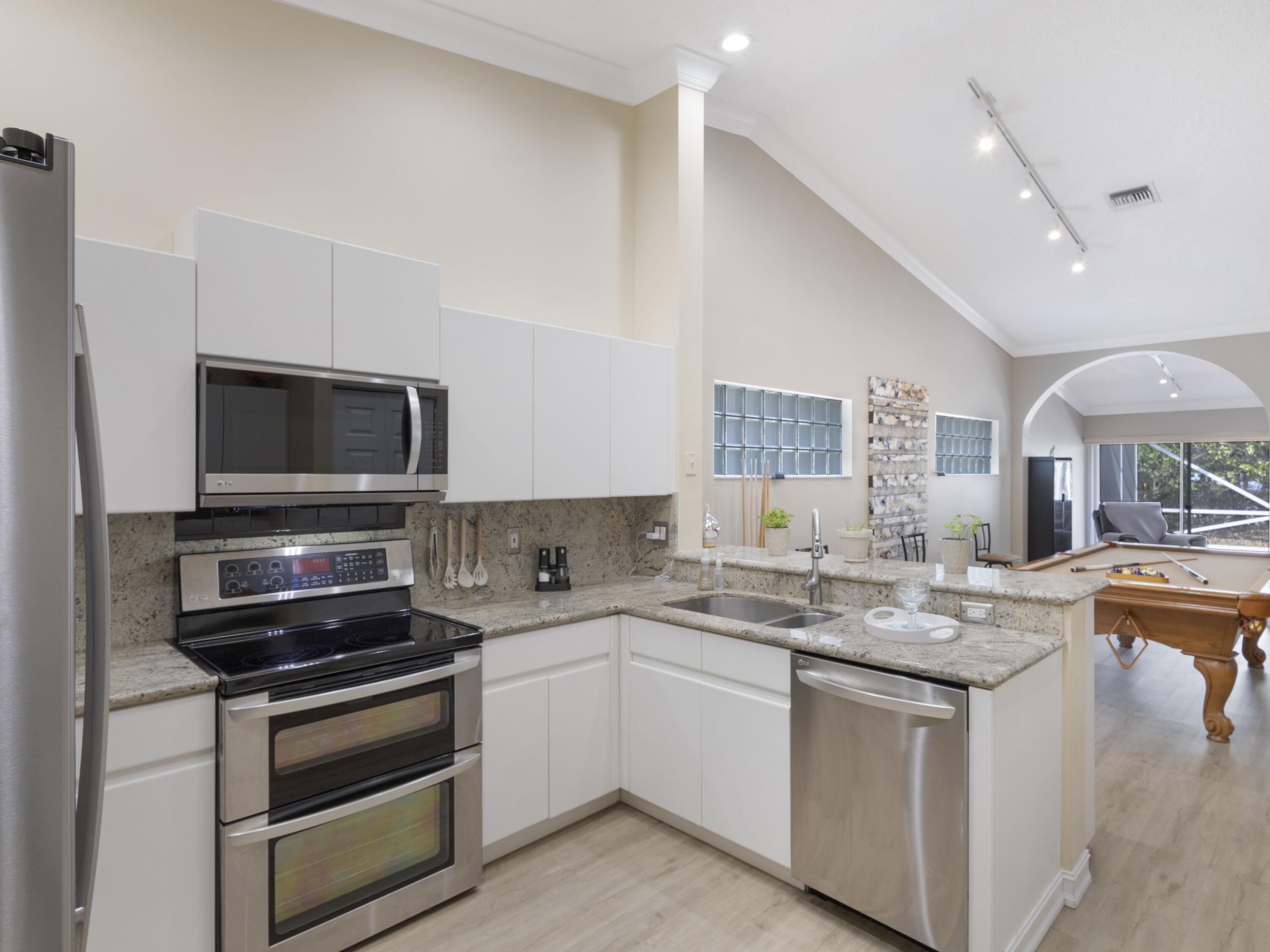 9734 Harbour Lake Circle Boynton Beach, FL 33437 - Photo 5 of 41 a kitchen with a sink stove and microwave