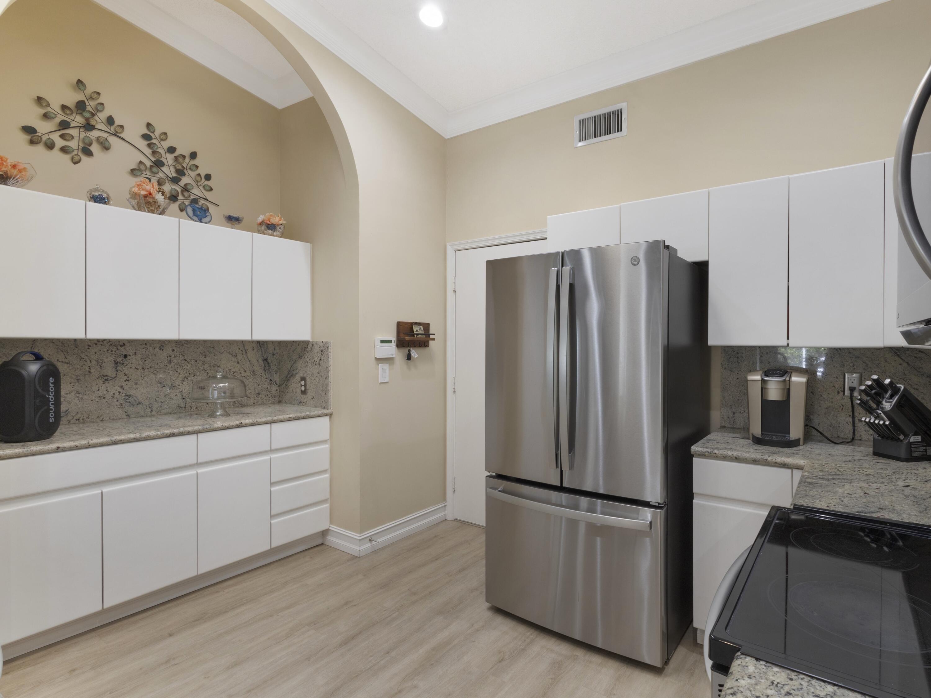 9734 Harbour Lake Circle Boynton Beach, FL 33437 - Photo 7 of 41 a kitchen with granite countertop a refrigerator and a sink